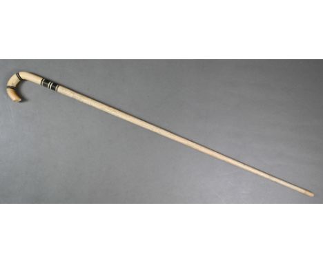 An antique South Seaas walking stick, carved from a narwhal tusk, with marine ivory handle, 87 cm long
