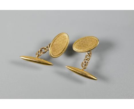 A pair of 9ct yellow gold cufflinks with engine turned decoration and chain link torpedo backs, approx 4.4g