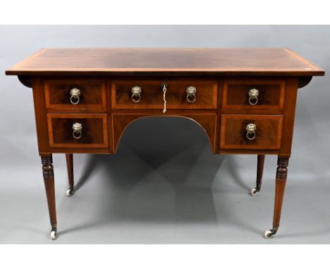 An Edwardian Sheraton Revival cross-banded red walnut ladies writing desk, with five drawers, raised on slender turned legs t