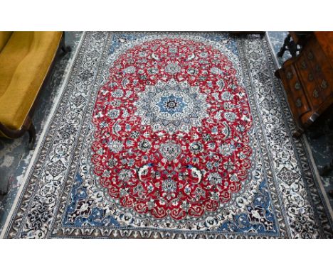 A good contemporary Persian part silk Nain carpet, the red ground centre panel with pale blue corners and camel ground border