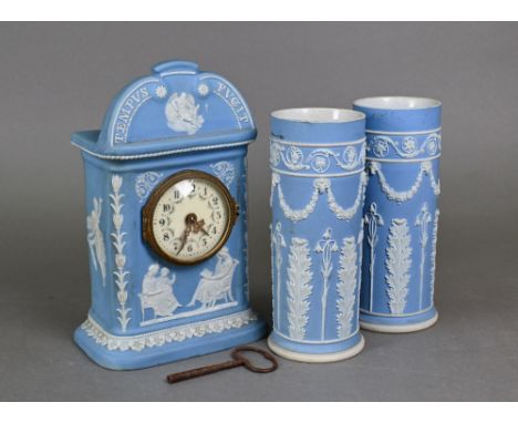 An Edwardian Wedgwood pale blue Jasper three piece clock garniture set, the case inscribed 'Tempus Fugit' over Father Time in
