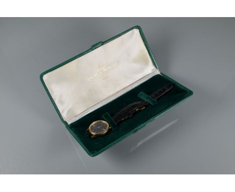A ladies Baume & Mercier 18ct gold wristwatch, manual with sapphire set winder, oval, the oval tigers eye dial with gilt bato