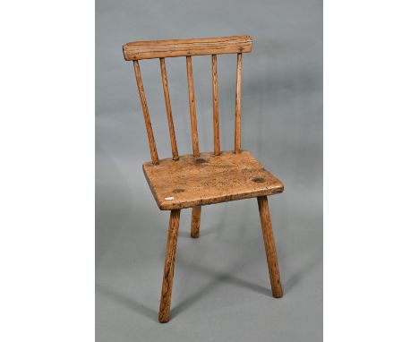 A primitive Welsh sycamore and ash stick back three legged chair, 19th century, 38 cm w x 31 cm, the seat 37 cm h Section of 