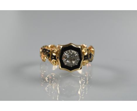 An early 19th century mourning ring with black enamel and diamond set centre, shoulders showing remnants of black enamel, ins