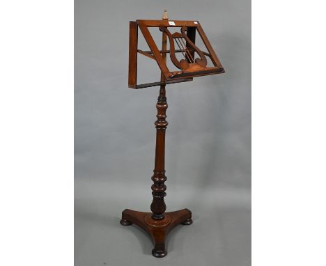A Victorian mahogany music stand, the single easel with lyre centre raised on a rise and fall support to a tri-form base