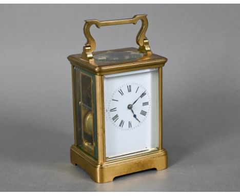 A traditional lacquered brass carriage clock, then two train 8-day movement with white enamelled Roman numeral dial, striking