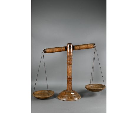 A set of antique fruitwood dairy pillar weighing scales, with conforming dished pans, 18 cm dia. from leather suspenders, on 