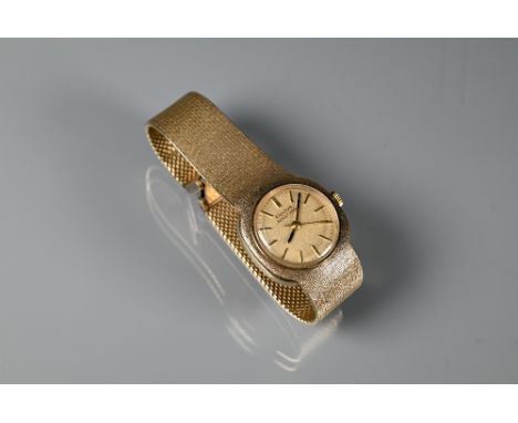 A vintage Bulova 9ct gold ladies wristwatch, champagne dial with integral textured bracelet, 43.8g all-in