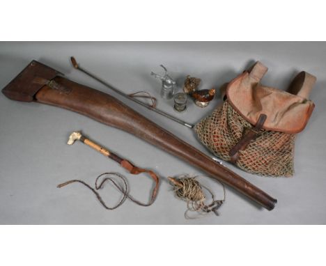 An antique leather gunslip 112 cm long o/a, to/w a canvas game bag with net and webbing strap, a malacca whip with carved bon