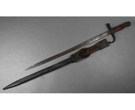 A Turkish bayonet, the 52 cm fullered blade with double-edged tip and top rib, the hilt with two-piece wood grip, Arabic insc