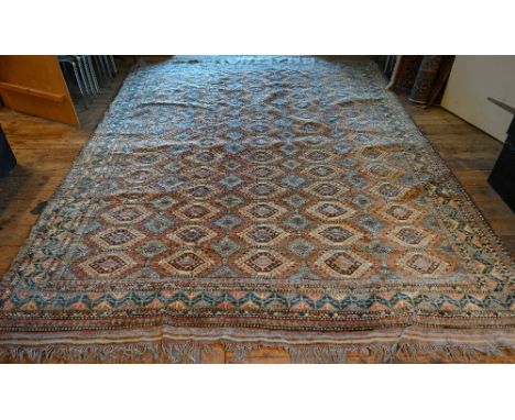 A vintage Turkish carpet, repeating geometric design on pale terracotta ground and kilim finished ends, 350 x 264 cm