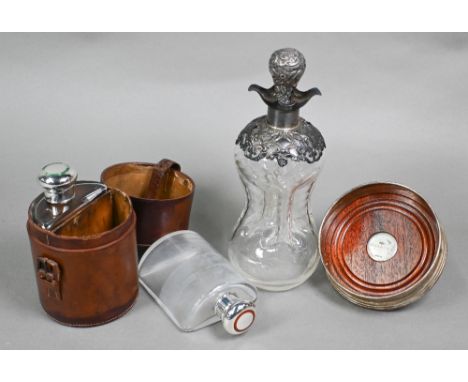 An Edwardian cased pair of glass huntsman's spirit flasks of semi-circular form, the silver bun covers with green and red ena