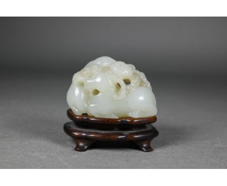 An 18th century Chinese jade carving of three rams, sanyang, with swirling clouds and a yinyang symbol between them, Qianlong