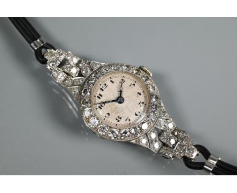 A platinum and diamond set ladies wristwatch, the Art Deco style diamond set surround with engine turned dial and blue steel 