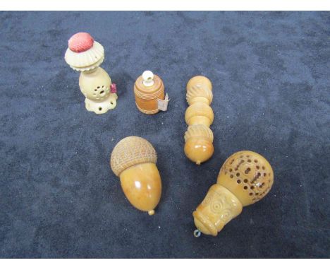 A Victorian vegetable ivory acorn-shaped thimble-holder with metal thimble. four other 19th Century vegetable ivory items: a 