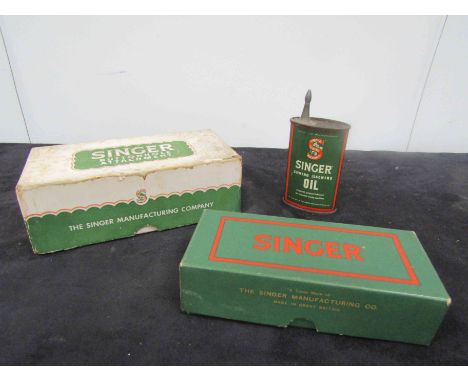 A Singer sewing machine button hole attachment in original box. A Singer box of isewing machine feet etc. A can of Singer sew