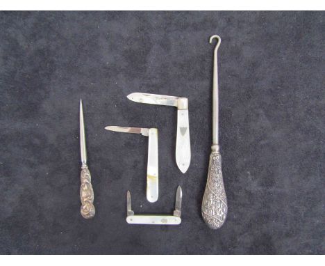 Two silver-handled button hooks. A folding pen knife with silver blade and mother-of-pearl handle. Sheffield 1928. Two simila