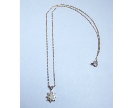 A diamond and opal pendant on 14 carat white gold chain