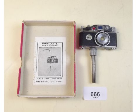 A novelty 'Photolite' lighter in the form of a camera with compass by the Oriental Co. Ltd