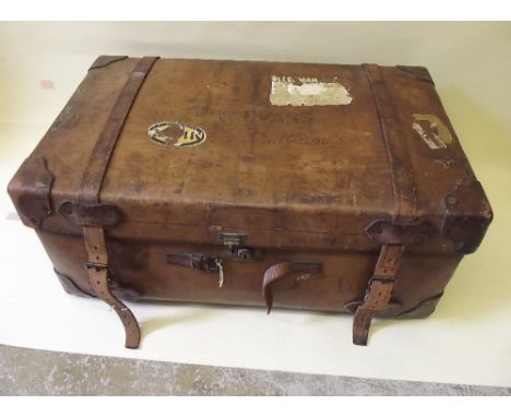 An antique leather trunk with leather straps