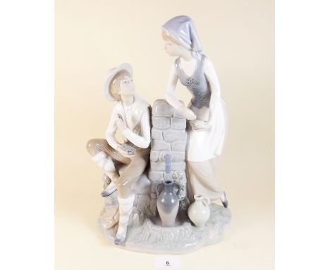 A large Lladro Nao group boy and girl at waterspout, 36cm