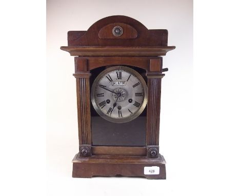 A late 19th century architectural alarm mantel clock with bell to top of case