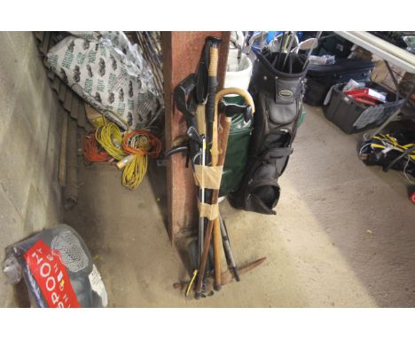 A quantity of various items to include walking sticks, litter pickers, pick axe, shovel etc.