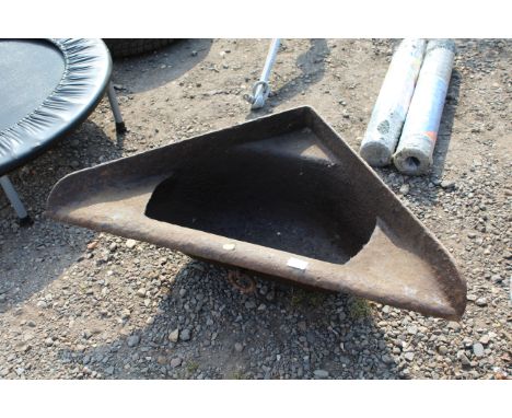 A cast iron corner feed trough