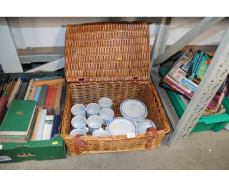A wicker hamper and contents of teaware