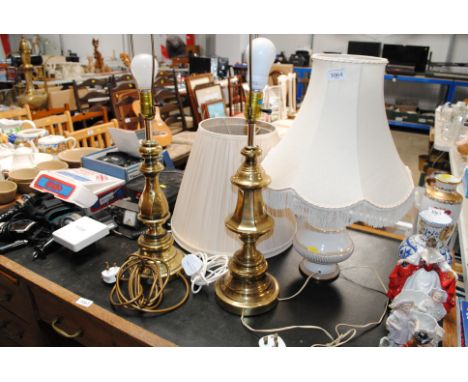 A pair of brass table lamps and shades and a porcelain table lamp with shade 