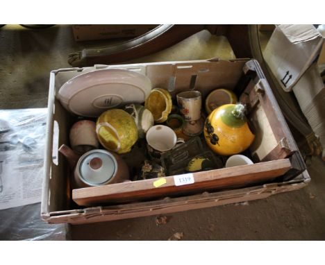 A plastic crate and quantity of decorative china to include tiled board, painted teapot etc.