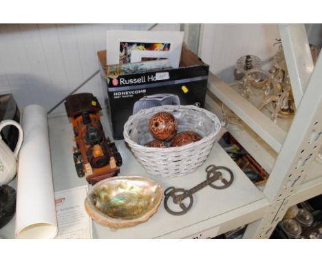 A model wooden train; an Abalone shell; a horses bit; books etc.