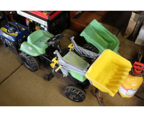 A child's Rolly Toys pedal tractor with front loader and trailer