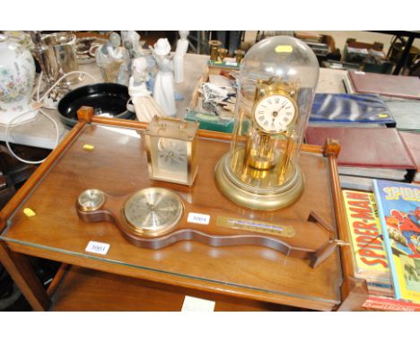 An anniversary clock, a barometer and a quartz Legend clock