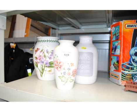 A Poole pottery floral decorated baluster vase; a Portmeirion baluster vase and another 