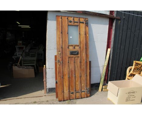 An exterior door with centred window panel measuring approx. 80cms wide x 200cms high, with fitted letter box and knocker han