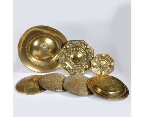 A collection of 17th Century and later brass ware, to include an alms dish, warming pan lids, a wall sconce, a longcase clock