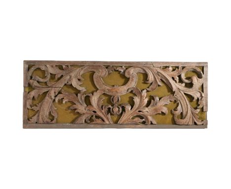An 18th century carved tracery panel, with pierced acanthus leaf and scroll decoration, on a later baize backing, 82cm wide, 