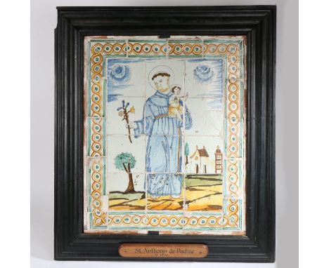 A Delft tile panel depicting Saint Anthony of Padua, housed in a substantial black painted fame with plaque "St Anthonu de Pa