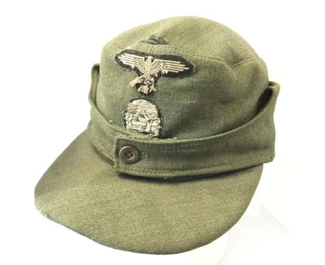 WW2 Third Reich Waffen SS Einheitsfeldmütze M43 field cap. Worn two piece BeVo Eagle and Deathshead insignia to front of cap.