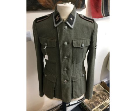WW2 Third Reich Waffen SS 1943 pattern Feldbluse field tunic. Regulation SS cut tunic with five button front and two holes fo