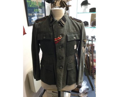 WW2 Third Reich Waffen SS 1943 pattern Feldbluse field tunic. Regulation SS cut tunic with five button front and two ramp hol
