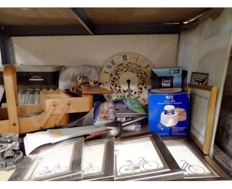 Shelf of mixed items including a sewing box with contents, a clock and a coin sorter. Not available for in-house P&amp;P 