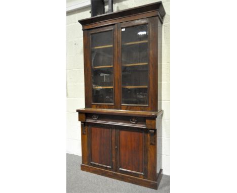 An early 20th century mahogany bookcase cabinet, the upper section with twin glazed doors opening to adjustable shelves, the 