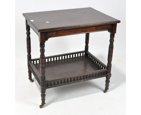 An early 20th century rectangular mahogany side table with lower galleried shelf and on turned supports and casters, 71cm x 5