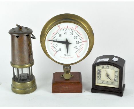 An antique coal miners lamp, having a copper and brass casing, height 22cm, together with a Smiths mantle clock in a bakelite