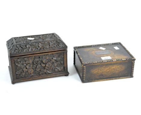 A wooden tea caddy and silver mounted box, the tea caddy of sarcophagus form and heavily carved with roses and foliage, conta