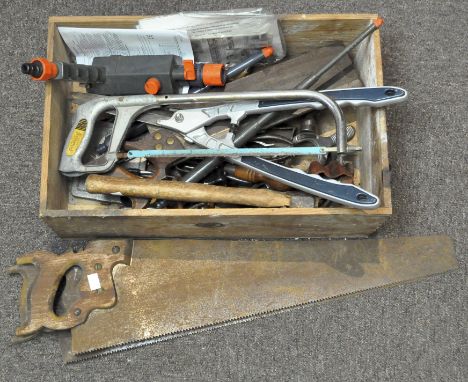 A collection of vintage tools, including saws, a pair of shears, an axe, wrenches and more, all contained within a wooden box