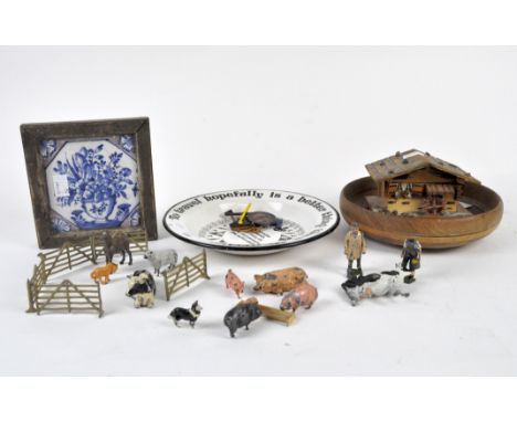 A selection of collectables, comprising a circular enamel bowl, lead farm animals, a Delft tile and a musical box modelled as