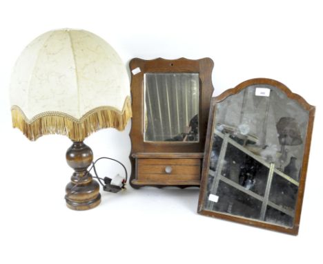 An early 20th century oak mirror and shelf, an arched rectangular dressing-table mirror, and a turned wood lamp, the first wi